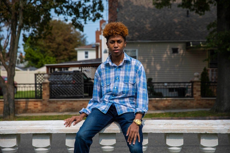 Rainier Harris, a senior at Regis High School, near his home in Queens.Credit...Hiroko Masuike/The New York Times