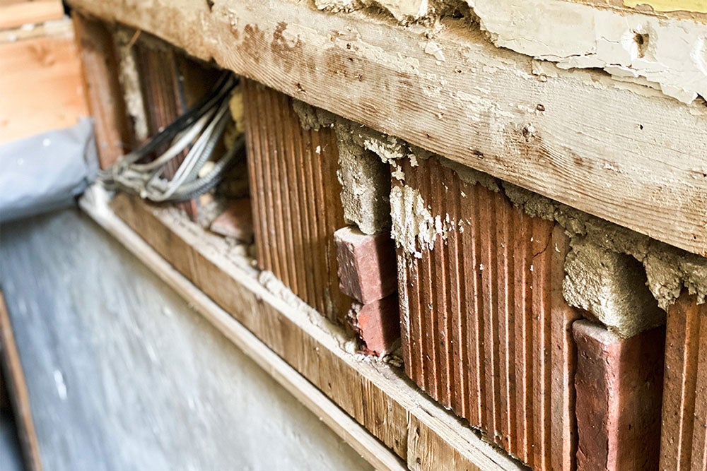 The removal of drywall during mold remediation is seen after a basement flood. Catherine McQueen/Getty Images