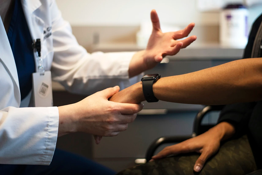 Dr. Maria Codreanu, a cardiologist, talks with Liza Fisher at Vital Heart & Vein in Humble, Texas, on March 7.Mark Felix / The Washington Post via Getty Images file