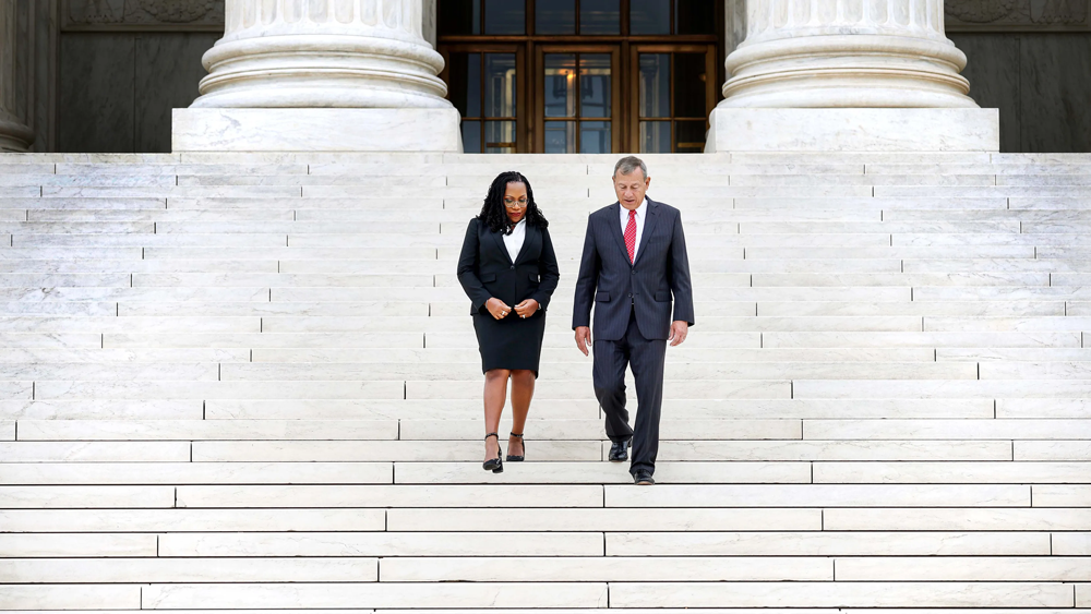 US Supreme Court Associate Justice Ketanji Brown Jackson and Chief Justice John Roberts walk down the steps of the Supreme Court by Anna Moneymaker at Getty Images