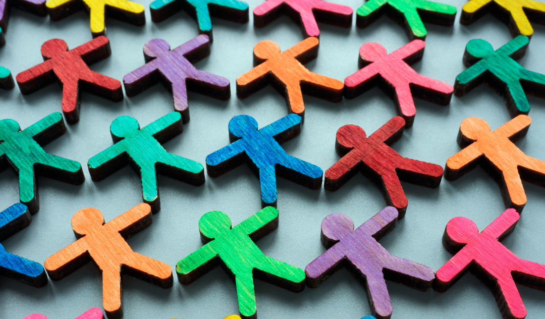 Rows of multi-colored wooden figurines of people, RARE Workgroup