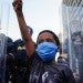 A young boy raises his fist for a photo by a family friend during a demonstration on May 31, 2020 in Atlanta, Ga. Across the country, protests have erupted following the recent death of George Floyd while in police custody in Minneapolis, Minnesota. Elijah Nouvelage, Getty Images