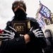 Some images on display at the Capitol riot on Jan. 6 have raised concerns that extremist groups are cloaking themselves in biblical language to justify their actions. // John Minchillo, AP
