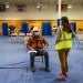 A volunteer, right, speaks with a person who received a Covid-19 vaccine shot at the University of New Mexico's Gallup campus in Gallup, N.M., on March 23.Cate Dingley / Bloomberg via Getty Images file