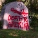 Words spray painted in red were scrawled across the front of the stone monument located on Waltham Common.