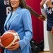 Kamala Harris holding a basketball among basketball players